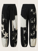 Load image into Gallery viewer, Front and back product views of black and cream patchwork joggers